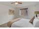 Bright bedroom featuring a ceiling fan and a comfortable bed with a window view at 21 N Washington St # 301, Denver, CO 80203