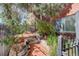 Brick walkway up to the front entrance is surrounded by mature shade trees and manicured green landscaping at 21 N Washington St # 301, Denver, CO 80203