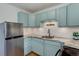 Charming kitchen with stainless steel refrigerator and updated countertops at 21 N Washington St # 301, Denver, CO 80203