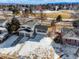 Lovely aerial view of a home in a residential area with snow covered yard at 6190 W Canyon Ave, Littleton, CO 80128