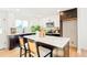 Modern kitchen with a center island, stone countertops, and bright lighting at 6190 W Canyon Ave, Littleton, CO 80128