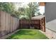 Private backyard featuring a well-maintained lawn, wooden fence, and access gate at 4251 Perry St, Denver, CO 80212