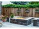 Inviting stone fire pit surrounded by a stone patio and lush greenery, perfect for outdoor entertaining at 4251 Perry St, Denver, CO 80212