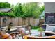 Scenic backyard with a fire pit, outdoor seating, lush landscaping, and a tranquil water feature at 4251 Perry St, Denver, CO 80212