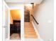 Stairwell to basement with wood stairs and stone wall accent at 4251 Perry St, Denver, CO 80212