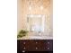 Elegant bathroom vanity features a mosaic mirror, granite countertop, and dark wood cabinetry at 4251 Perry St, Denver, CO 80212
