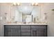 Bathroom featuring a dual vanity, large mirror, and mosaic tile backsplash at 4251 Perry St, Denver, CO 80212
