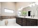 Modern bathroom featuring double sinks, a soaking tub, and sleek finishes at 4251 Perry St, Denver, CO 80212