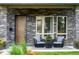 Charming front porch with stone accents, comfortable seating, and stylish decor, creating a cozy outdoor space at 4251 Perry St, Denver, CO 80212