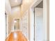 Bright hallway featuring hardwood floors, neutral walls, and white doors at 4251 Perry St, Denver, CO 80212