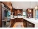 Modern kitchen with stainless steel appliances, wood cabinets, and an island with white countertop at 4251 Perry St, Denver, CO 80212