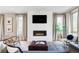 Cozy living room with a modern fireplace, large windows, comfortable seating, and stylish decor at 4251 Perry St, Denver, CO 80212