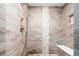 Stylish walk-in shower with stone floor and designer tile at 4251 Perry St, Denver, CO 80212