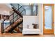 Modern staircase with black metal railings, wooden steps, and a cozy seating nook at 4251 Perry St, Denver, CO 80212