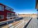 Spacious balcony with a metal railing and views of the surrounding neighborhood and open space at 46565 Avery Ln, Bennett, CO 80022