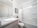 Clean bathroom featuring a shower-tub, white tile, marble countertop sink, and bright light at 46565 Avery Ln, Bennett, CO 80022