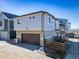 Contemporary two-story home with a two-car garage, light-blue siding, and a concrete driveway at 46565 Avery Ln, Bennett, CO 80022
