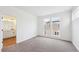 Bright bedroom with neutral carpet and bathroom ensuite with a modern vanity at 1255 Penner Dr, Erie, CO 80026