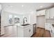 Stylish kitchen features hardwood floors, stainless steel dishwasher, island sink and exterior patio access at 1255 Penner Dr, Erie, CO 80026