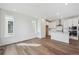 Bright kitchen showcases hardwood floors, modern white cabinetry, stainless steel appliances, and a center island at 1255 Penner Dr, Erie, CO 80026