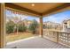 Covered porch with wood floors offering a view of the fenced-in backyard and neighborhood at 844 Dakota Ln, Erie, CO 80516