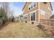 The backyard features a grassy area and a partial fence with access via sliding glass doors at 844 Dakota Ln, Erie, CO 80516