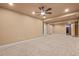 Finished basement area with neutral carpeting and a view into another room at 844 Dakota Ln, Erie, CO 80516