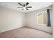 Cozy bedroom with ceiling fan, neutral carpet, and a bright window at 844 Dakota Ln, Erie, CO 80516