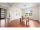 Bright dining room featuring hardwood floors, modern lighting, and a table set for a meal at 844 Dakota Ln, Erie, CO 80516