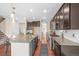 Spacious kitchen features stainless appliances, dark cabinets, granite countertops, and a large kitchen island at 844 Dakota Ln, Erie, CO 80516
