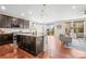 Open kitchen featuring stainless steel appliances, an island with granite countertops, and dark wood cabinetry at 844 Dakota Ln, Erie, CO 80516