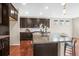 Modern kitchen featuring stainless steel appliances, granite countertops, an island, and dark wood cabinetry at 844 Dakota Ln, Erie, CO 80516