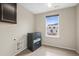 Bright laundry room with storage cabinets and natural light from the window at 844 Dakota Ln, Erie, CO 80516