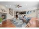 Bright, open living room features a cozy fireplace and a ceiling fan, seamlessly connected to the kitchen at 844 Dakota Ln, Erie, CO 80516