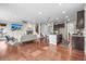 Open concept living room with a fireplace, TV, and modern kitchen with an island at 844 Dakota Ln, Erie, CO 80516