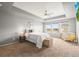 Main bedroom featuring a tray ceiling, carpet, and bright windows at 844 Dakota Ln, Erie, CO 80516