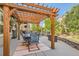 Outdoor patio with a wooden pergola structure, dining set, and grill, designed for enjoyable outdoor gatherings at 13645 Mariposa St, Broomfield, CO 80023