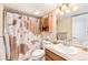 Bathroom has a combination shower-tub and vanity, with an adjacent linen closet at 9077 W 88Th Cir, Denver, CO 80021