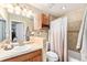 Bathroom features a combination shower-tub and decorative tile, with an adjacent linen closet at 9077 W 88Th Cir, Denver, CO 80021