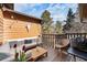 Cozy wooden deck includes stylish outdoor seating and a view of the surroundings at 9077 W 88Th Cir, Denver, CO 80021