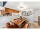 Cozy dining room showcases wood table, bench seating, and contemporary lighting at 9077 W 88Th Cir, Denver, CO 80021