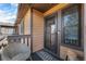 Inviting entryway features a charming welcome mat and secure screen door, offering style and security at 9077 W 88Th Cir, Denver, CO 80021