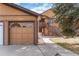 Attached garage showcases natural light and a private walkway to the home's entrance at 9077 W 88Th Cir, Denver, CO 80021