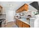 Well-lit kitchen equipped with modern appliances, ample countertop space, and sleek cabinets at 9077 W 88Th Cir, Denver, CO 80021