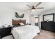 This main bedroom has a sliding glass door to the outside and stylish decor at 9077 W 88Th Cir, Denver, CO 80021