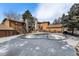 Community pool surrounded by brown townhomes and evergreen trees on a sunny day at 9077 W 88Th Cir, Denver, CO 80021