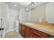 Bright bathroom featuring a walk-in shower, tile floors and a large vanity with counter space at 7831 Inverness Blvd, Englewood, CO 80112