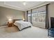 Spacious bedroom with neutral color palette, tray ceiling, ceiling fan, and three large windows at 7831 Inverness Blvd, Englewood, CO 80112