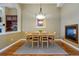 Bright dining room offers a cozy fireplace and seamless flow to living spaces at 7831 Inverness Blvd, Englewood, CO 80112