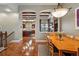 Dining room with seamless access to a modern kitchen and a cozy living area at 7831 Inverness Blvd, Englewood, CO 80112